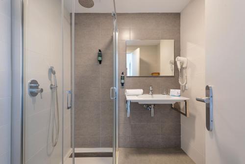 a bathroom with a shower and a sink at Welikehotel Fenix in El Arenal