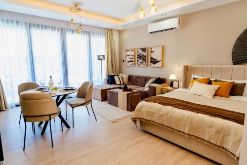 a bedroom with a bed and a dining room at Palmera Resort Wellness & Spa - Mountain & Pool View Studio 1 by Azur Prime in Vasilia