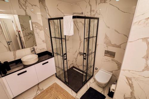a bathroom with a shower and a toilet at Palmera Resort Wellness & Spa - Mountain & Pool View Studio 1 by Azur Prime in Vasilia