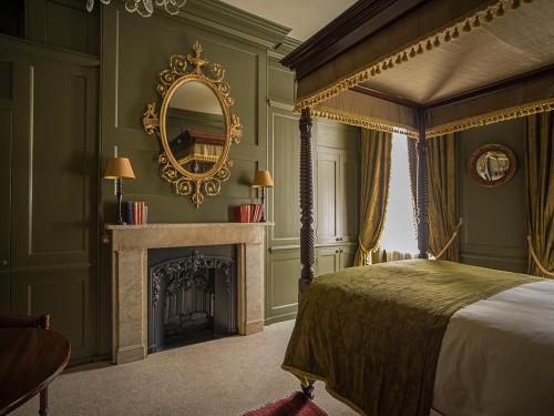 a bedroom with a canopy bed and a fireplace at Hazlitt's in London