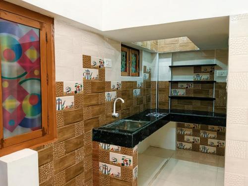 a bathroom with a sink and a counter top at Sri Ram Villa in Rāmeswaram