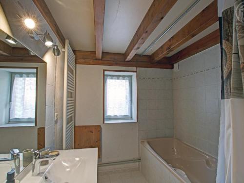 a bathroom with a tub and a sink at Gîte Les Hortensias à Pralong - Charme et Confort pour 4 Pers avec Internet - FR-1-496-117 in Pralong