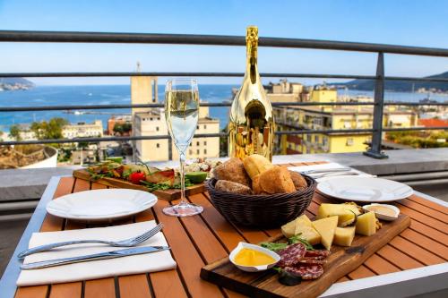 a table with a plate of food and a glass of wine at Allegroitalia La Spezia 5 Terre in La Spezia