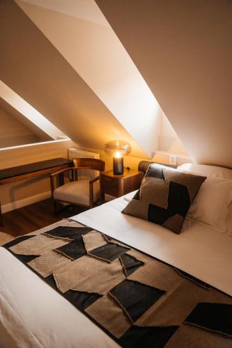 a bedroom with a bed and a chair in a room at Castle Hill Residence in Karlovy Vary