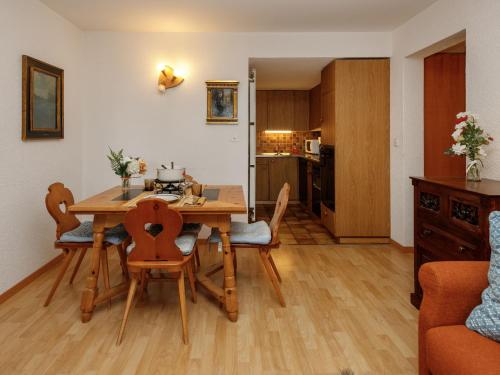 a kitchen and dining room with a table and chairs at Studio Terrasse Des Alpes 618 by Interhome in Crans-Montana