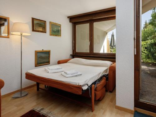 a small bedroom with a bed and a window at Studio Terrasse Des Alpes 618 by Interhome in Crans-Montana