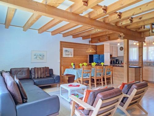 a living room with a couch and a table at Apartment Chalet Almis 5 by Interhome in Grindelwald