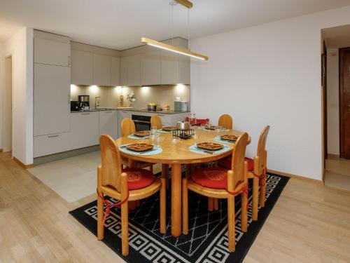 a kitchen and dining room with a table and chairs at Apartment Terrasse Des Alpes 917 by Interhome in Crans-Montana