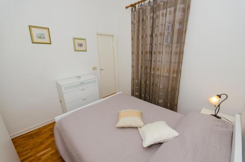 a bedroom with a bed with two pillows on it at Apartment Noemi in Rovinj