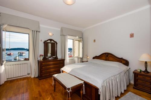 a bedroom with a large bed and a large window at Apartment Noemi in Rovinj