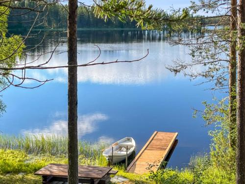 a boat on a dock on a lake at Holiday Home Harjula by Interhome in Nissi