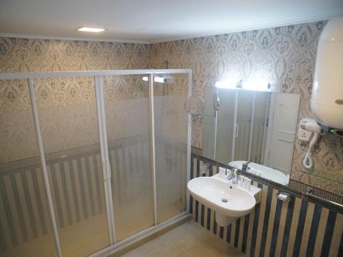 a bathroom with a shower and a sink at Amwaj Hotel in Alexandria