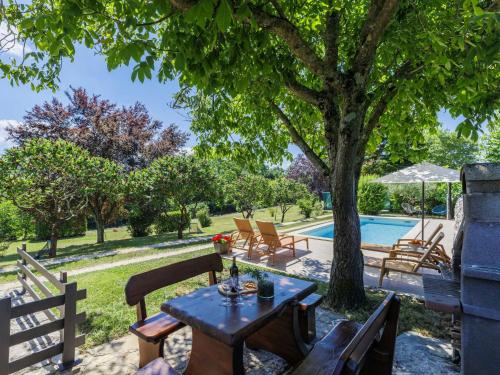a patio with a table and chairs next to a pool at Holiday Home Tomazin by Interhome in Pazin
