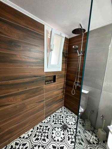 a bathroom with a shower with a glass door at Litus Amoris in Sidari