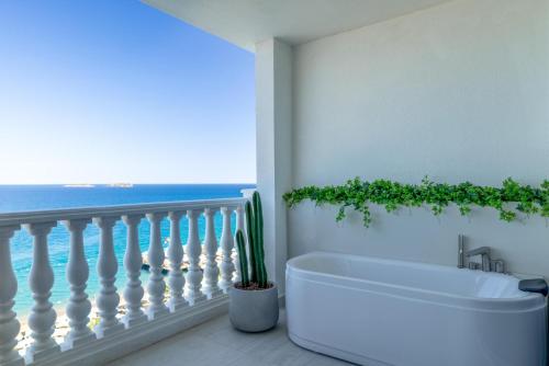 a bath tub in a bathroom with a view of the ocean at Nirvana Dolce Vita - Ultra All Inclusive in Tekirova
