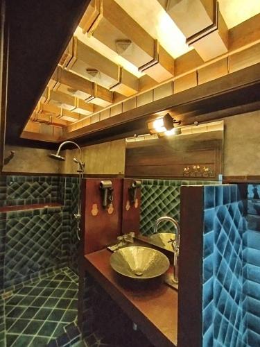 a bathroom with a sink and two faucets at Five Star Guest house in Chiang Mai