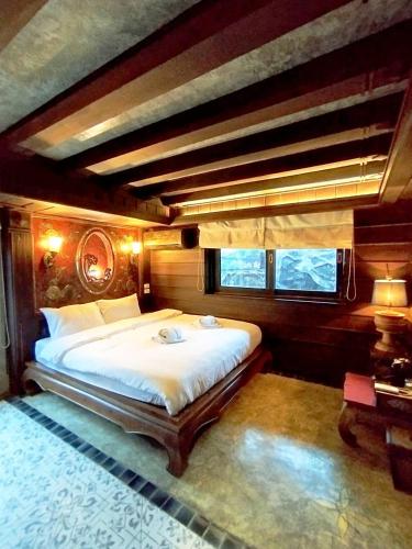 a bedroom with a large bed in a room at Five Star Guest house in Chiang Mai