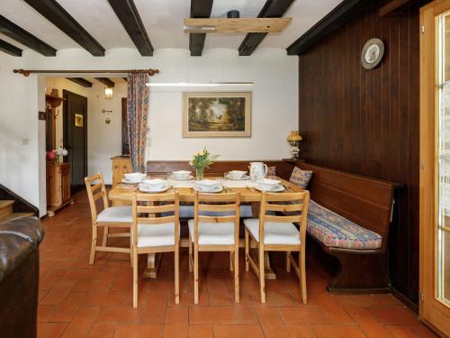 a dining room with a wooden table and chairs at Apartment Chalet L'Aube by Interhome in Vers L'Eglise
