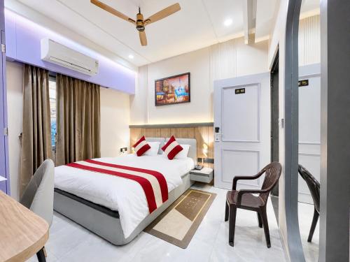a hotel room with a bed and a chair at NEAR SHREE RAM JANM BHOOMI - HOTEL SHREE RR - Wi-Fi - Parking- Luxury Rooms - Best Family Hotel In Ayodhya in Ayodhya