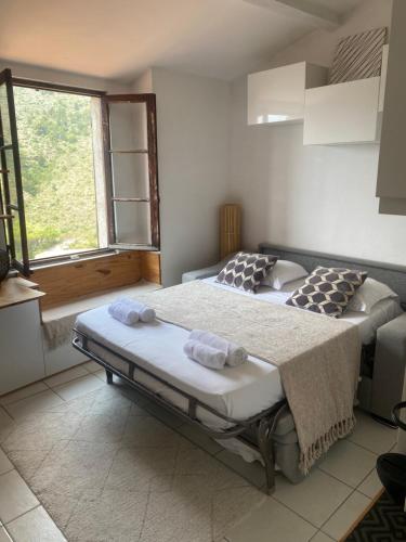 a bedroom with two beds and a window at Studio with sea and mountain view in Sainte-Agnès
