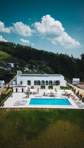 an aerial view of a building with a swimming pool at Moon Valley Comarnic in Sinaia