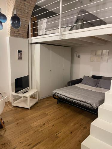 a bedroom with a bunk bed and a television at 16 zeros villa in Paralia Katerinis
