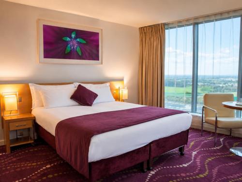 a hotel room with a bed and a large window at Louis Fitzgerald Hotel in Clondalkin