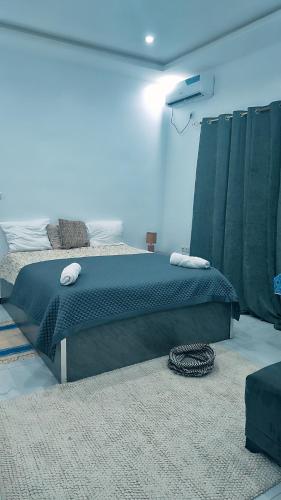 a bedroom with a large bed in a room at Villa Madiba in Somone