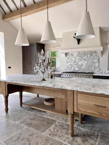 a large kitchen with a large marble table at Surrey Barn, Newly Renovated in Ripley
