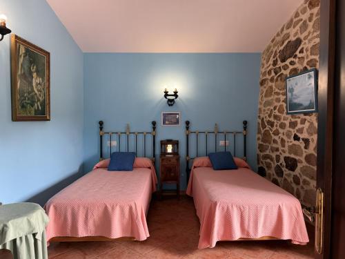 two beds in a room with blue walls at BLEU MAISON-PAZO 2 CL in Campo Lameiro
