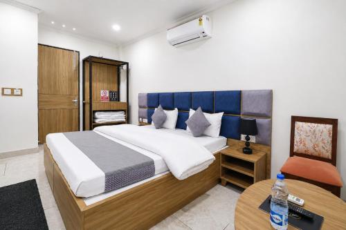 a bedroom with a large bed and a table at Hotel Andies in Mohali