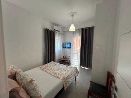 a small bedroom with a bed and a window at IRIS Apartment in Loutraki