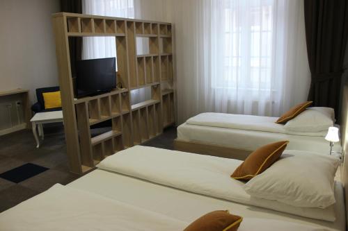 a hotel room with two beds and a television at Hotel Story in Sarajevo
