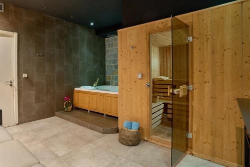 a bathroom with a tub and a glass shower at Hotel Casa del Mare - Amfora in Kotor