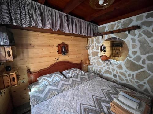 a bedroom with a bed in a log cabin at Naša kuća-Veruša in Veruša