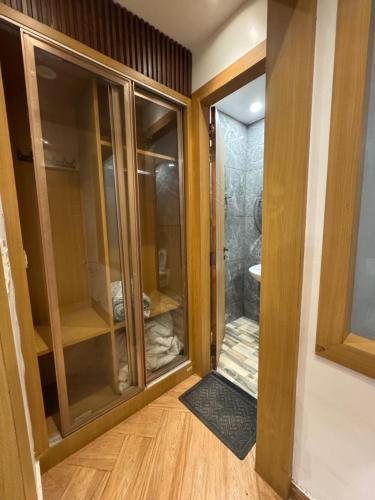 a bathroom with a glass door leading to a shower at HOTEL ELiTE in Pānīpat