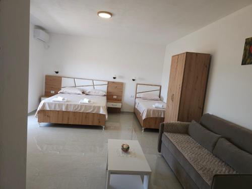 a living room with two beds and a couch at Caci Apartments in Gornji Štoj