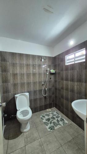 a bathroom with a toilet and a sink at NATIVE SOULS Beach Hotel in Induruwa
