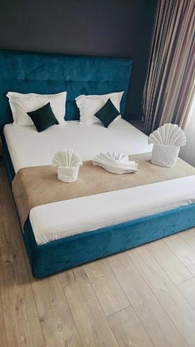 a large bed with two baskets on top of it at Apart Central in Orşova