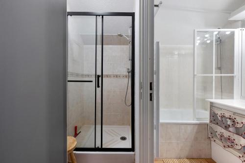a shower with a glass door in a bathroom at Valmeinier le Miras in Valmeinier