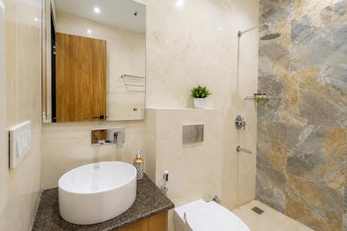 a bathroom with a white sink and a shower at Hotel Andies in Mohali