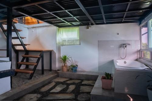 a bathroom with a bath tub and a sink at The Edge Villa & Retreat in Pokhara