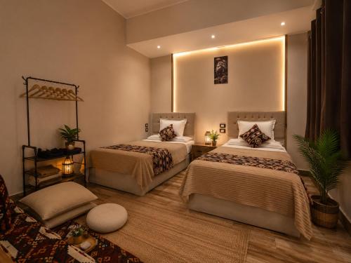 a bedroom with two beds and a couch at Grand Duplex in Aswan