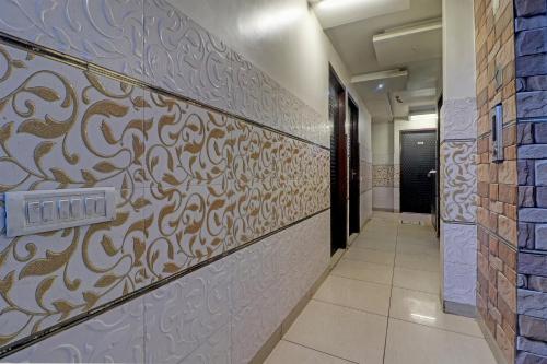 a hallway with a patterned wall in a building at Collection O The Legend Hotel, Hisar in Hisār