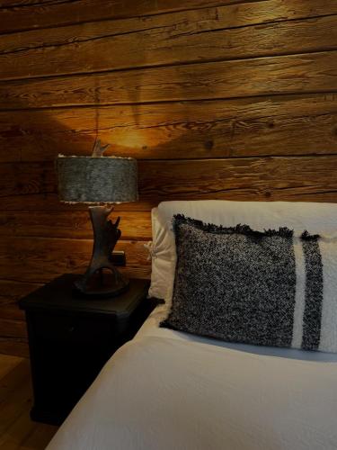 a bedroom with a bed with a lamp on a night stand at MOUNTAIN LODGE OBERJOCH - Allgäu in Bad Hindelang