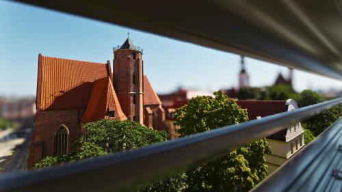 a view of a church from a balcony at Old Town Haston in Wrocław