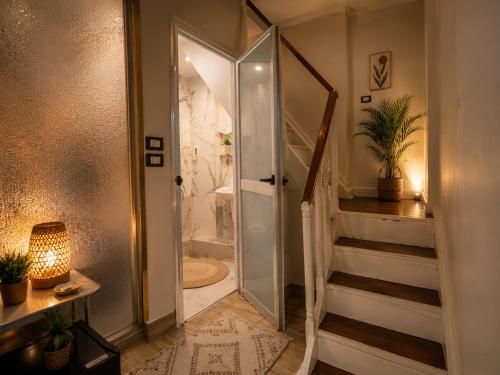 a bathroom with a walk in shower and a staircase at Grand Duplex in Aswan