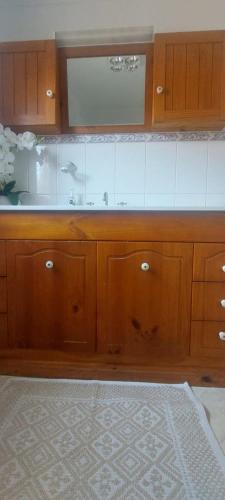 a kitchen with wooden cabinets and a microwave at Mary's Place in Devonport
