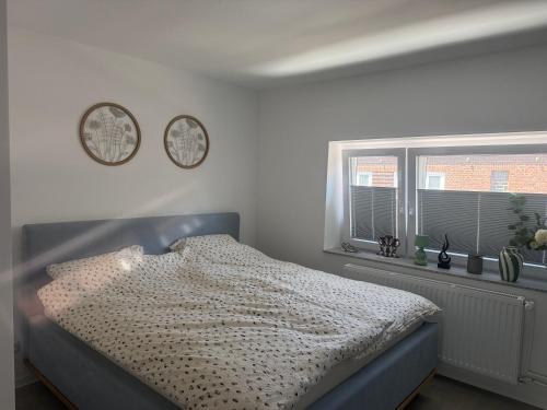 a bedroom with a bed and two clocks on the wall at Stillvolle Apartment NV in Neukirchen-Vluyn