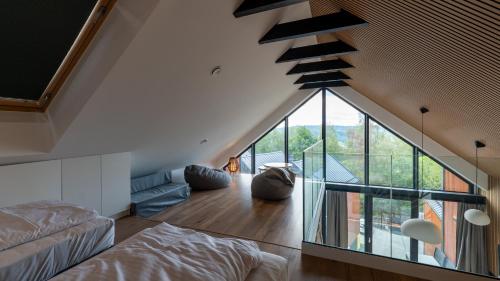 a loft conversion with a staircase and a living room at Wisła View, Sun&Snow in Wisła
